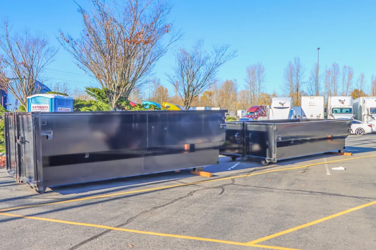 Professional dumpster rental service with roll-off container on residential driveway in Chena Ridge